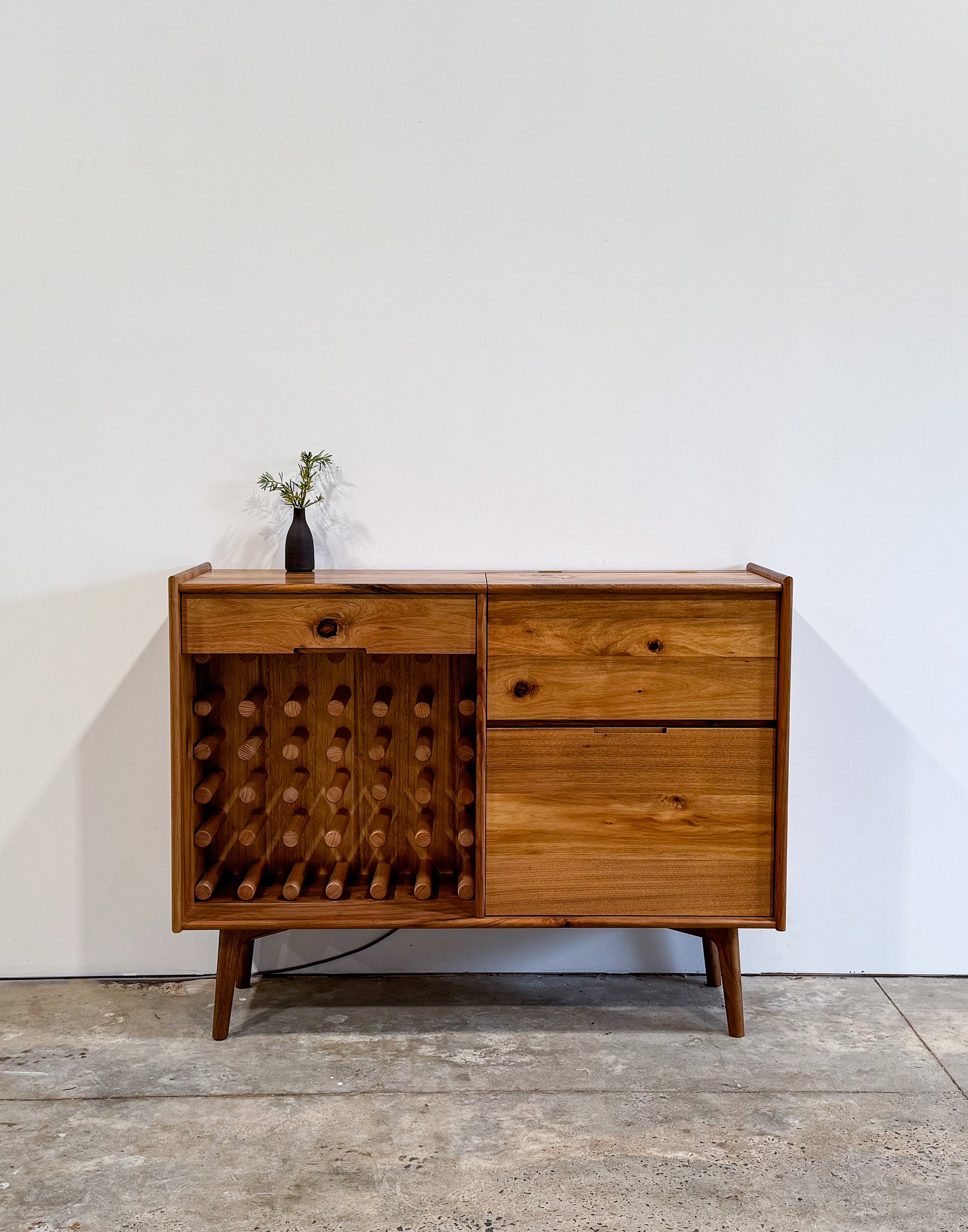 Dark brown timber drinks cabinet with wine rack and mirror inlay cocktail hatch and drawer. Handmade in Melbourne Australia from Tasmanian Blackwood