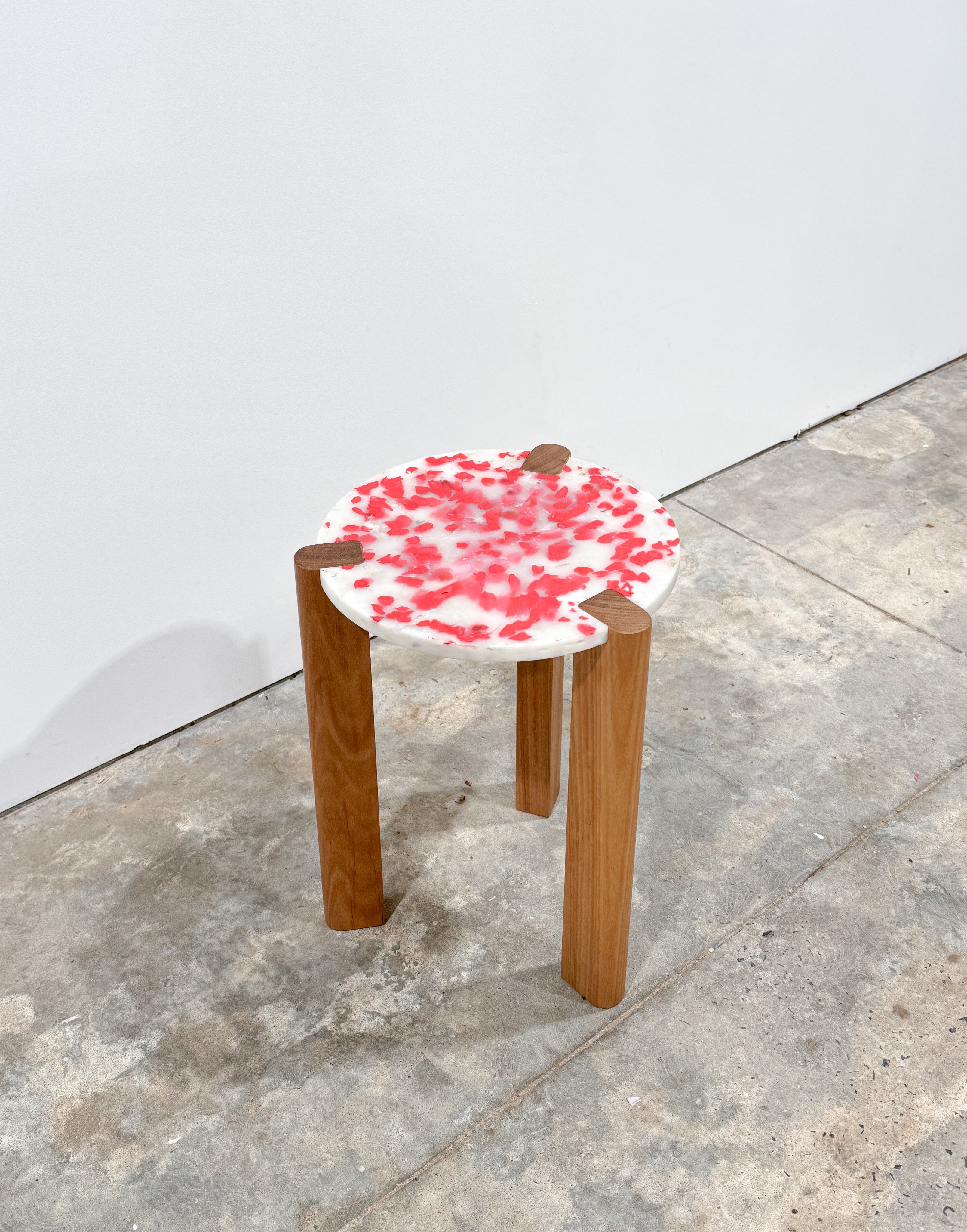 Short stool with 3 Tasmanian Oak timber legs and a red and white seat made from recycled soy sauce fish and milk bottles